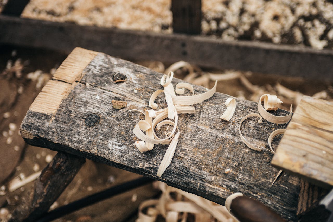 Home Rustic workbench covered in wood shavings, showcasing detailed craftsmanship.